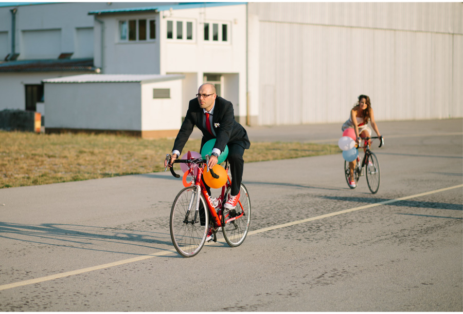 stylish groom riding a bike