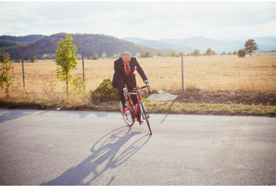 elegant groom riding a bicycle