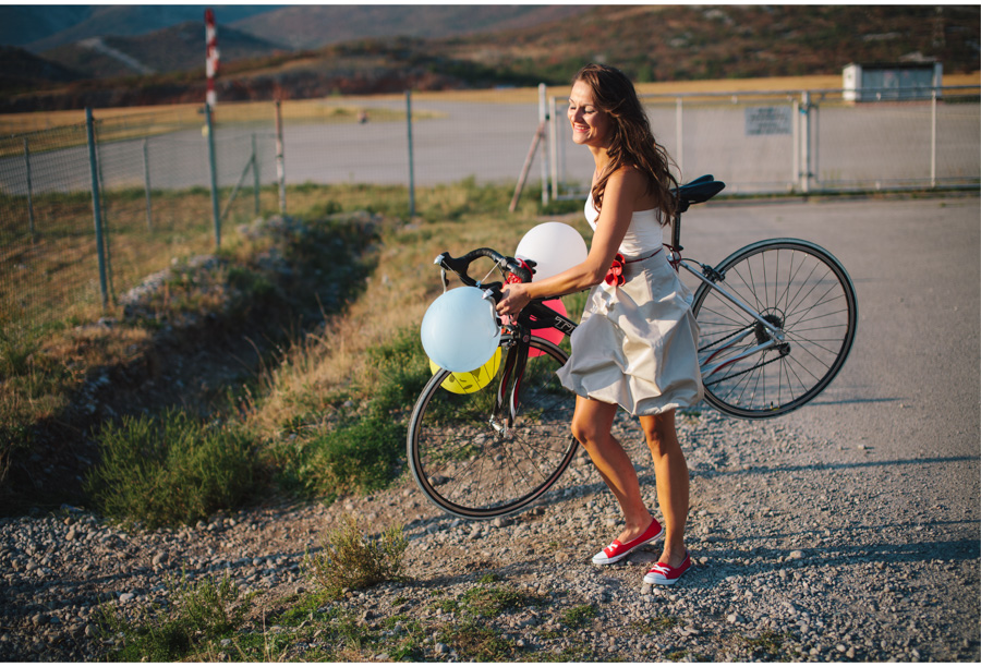 bride smiling holding a bike