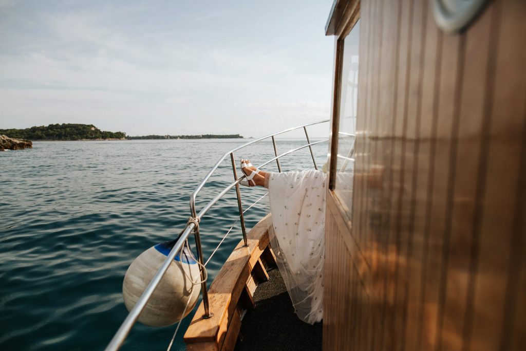 bride putting her feet up on the boat